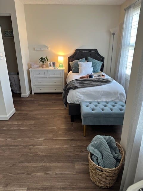 Senior bedroom with tufted bench and bedside lighting at Charter Senior Living of Northpark Place in Sioux City, IA