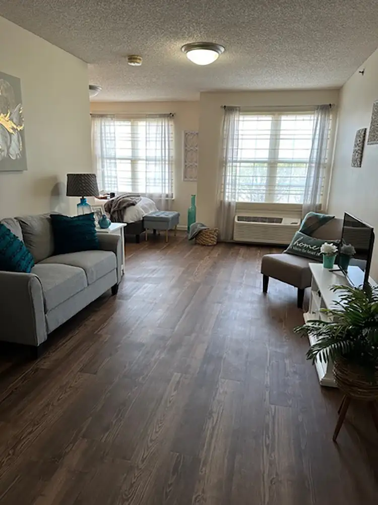 Open-concept senior apartment with bright windows and stylish furnishings in Sioux City, IA